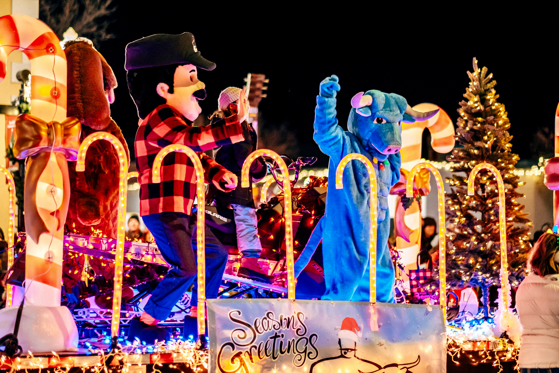Paul Bunyan & Babe The Blue Ox mascots riding on a float.