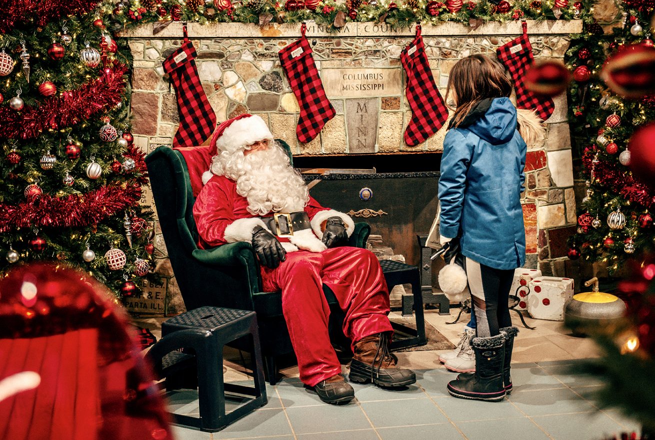 Santa with girl in Santa's Workshop.